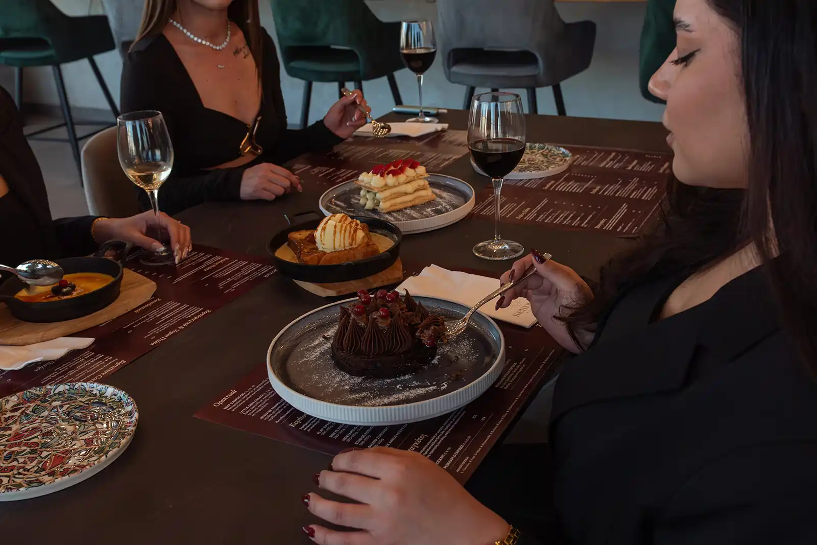 Guests enjoying desserts after dinner at Memories L’Entrecôte’s Restaurant Rooftop