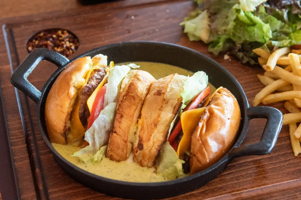 Gourmet burger served with signature sauce at Memories L’Entrecôte’s Restaurant Rooftop